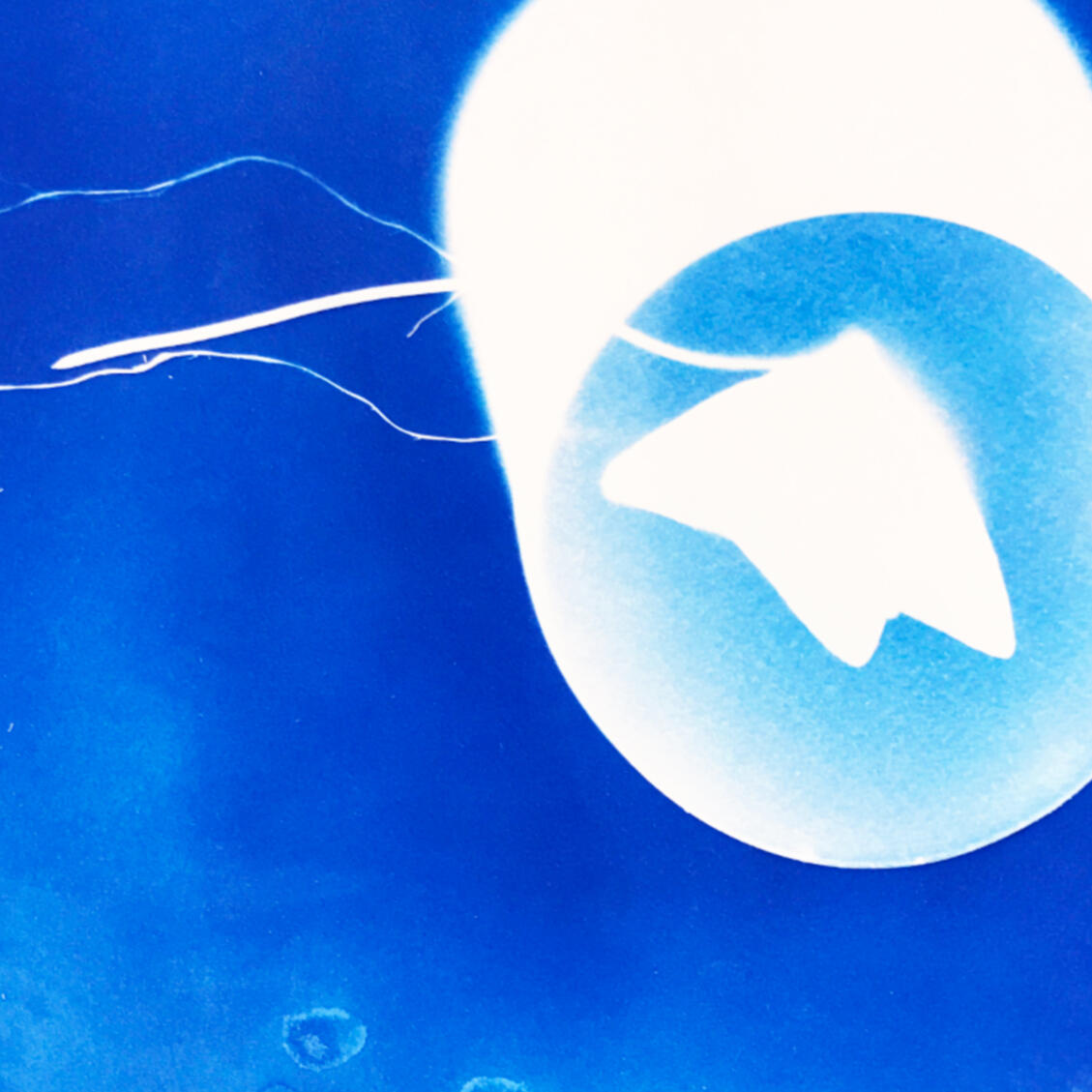 Image from Stone Soup event from 2023 Desert Biennial Project. Features bright orange diamond sign with black lettering spelling out Desert Biennial Project behind a sign made from dimensional lumber with Stone Soup painted in red on front of sign.