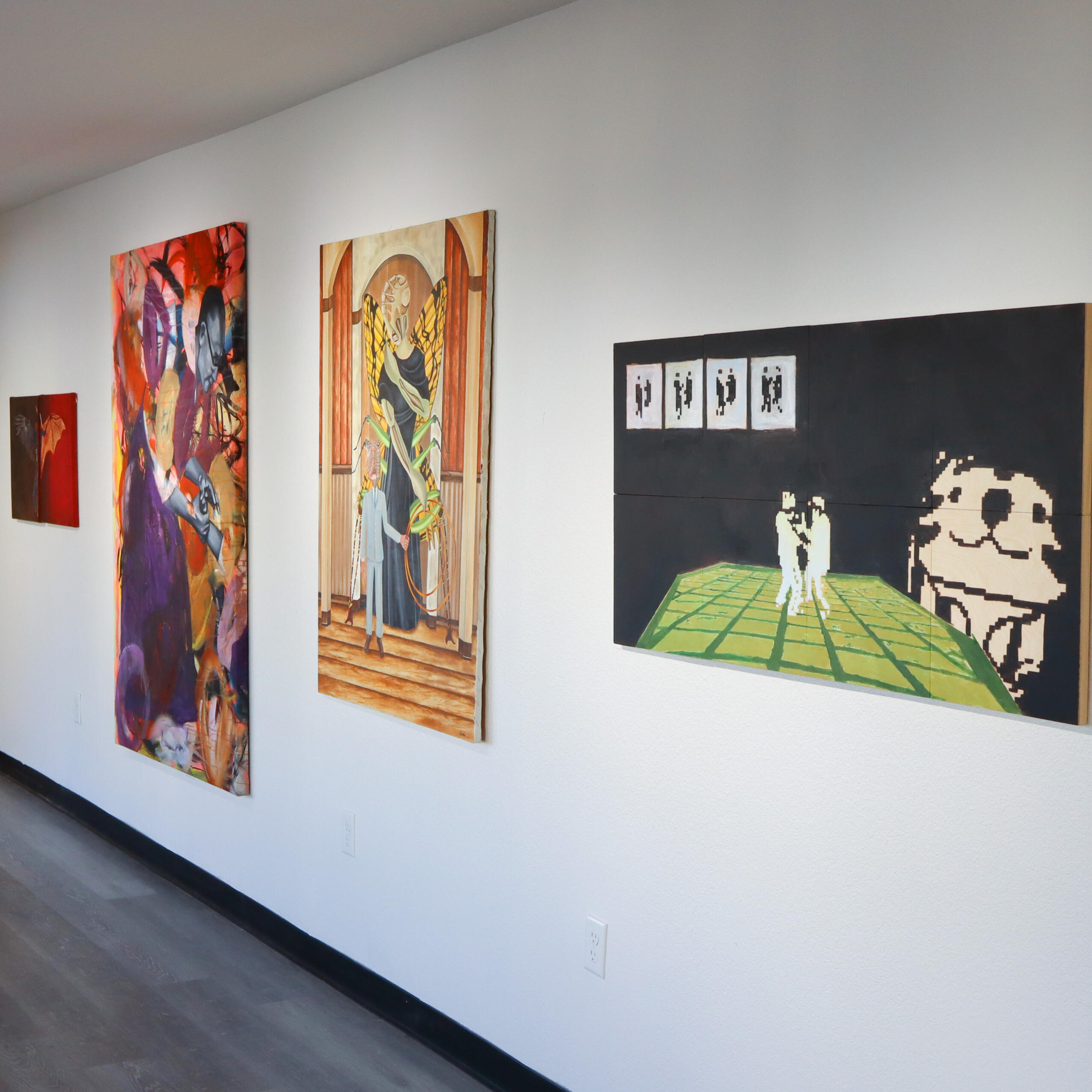 Image from Stone Soup event from 2023 Desert Biennial Project. Features bright orange diamond sign with black lettering spelling out Desert Biennial Project behind a sign made from dimensional lumber with Stone Soup painted in red on front of sign.